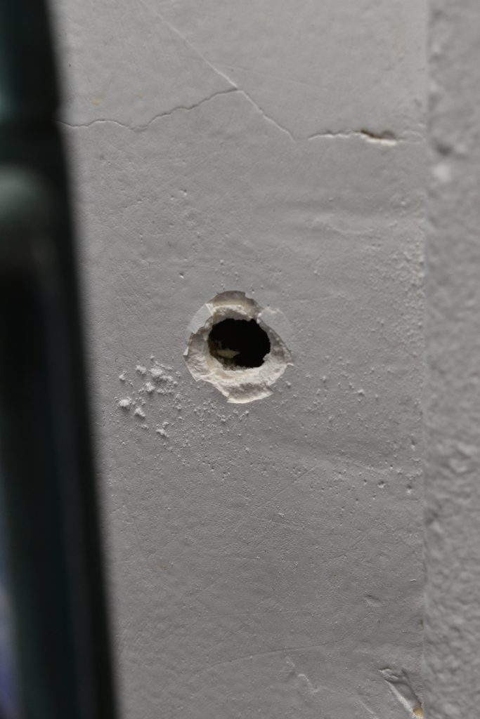 a bullet hole in a wall