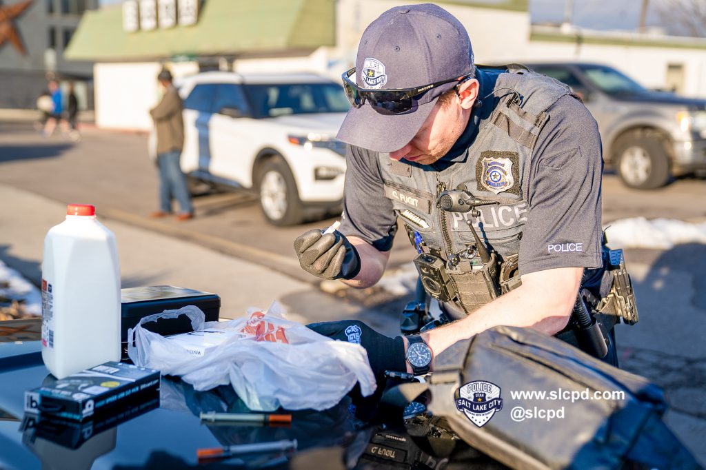 A police officer testing illegal drugs on a hood of a police car