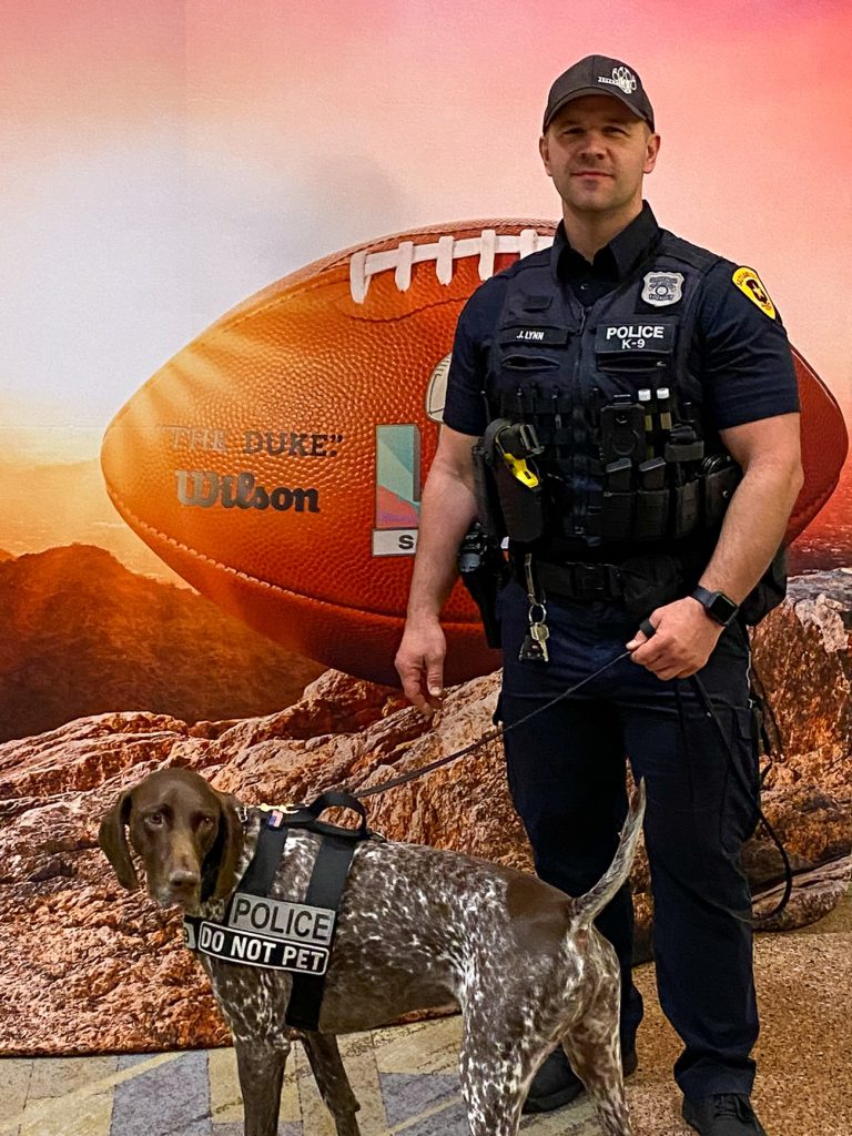 Photo of a police officer and his K-9 partner.