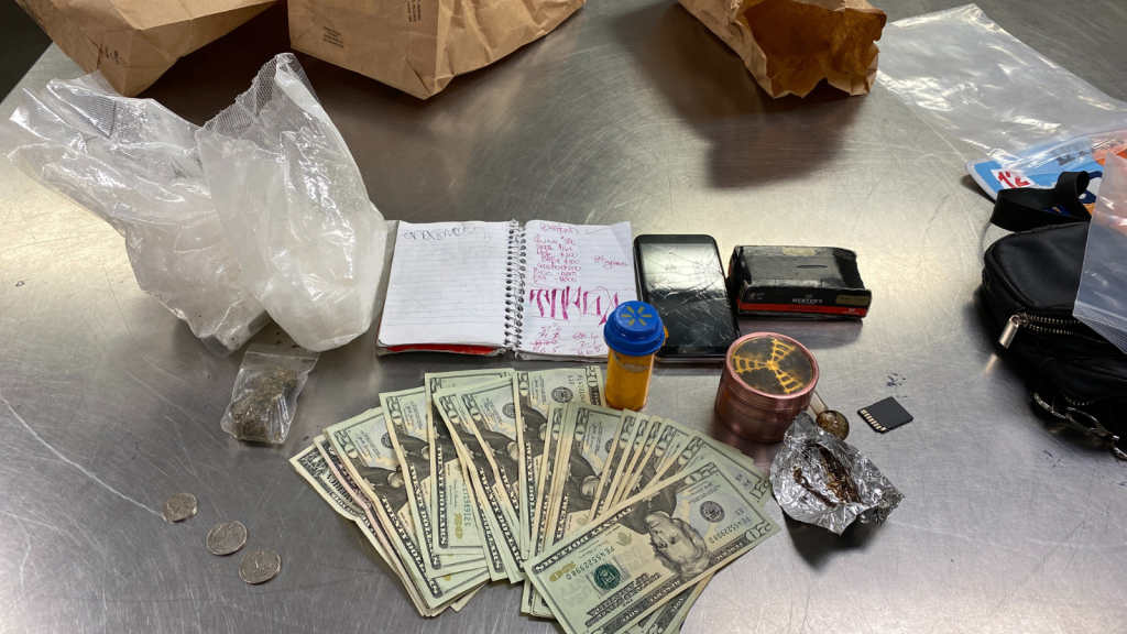 Photo of methamphetamine, cash, and drug paraphernalia.