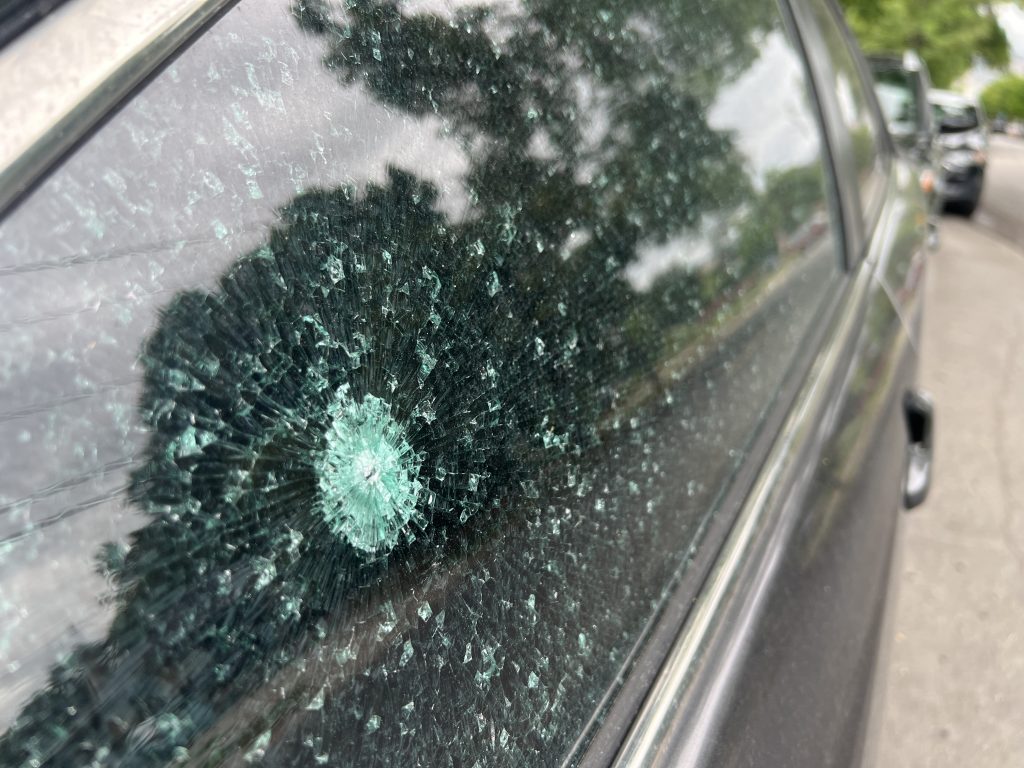 A close up shot of a partially shattered window.