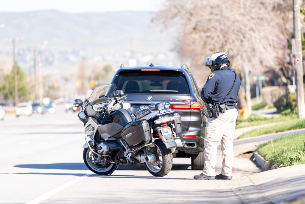 Photo: A Salt Lake City motorcycle officer conducts traffic education and enforcement on Foothill Drive (SLCPD photo; April 11, 2024).
